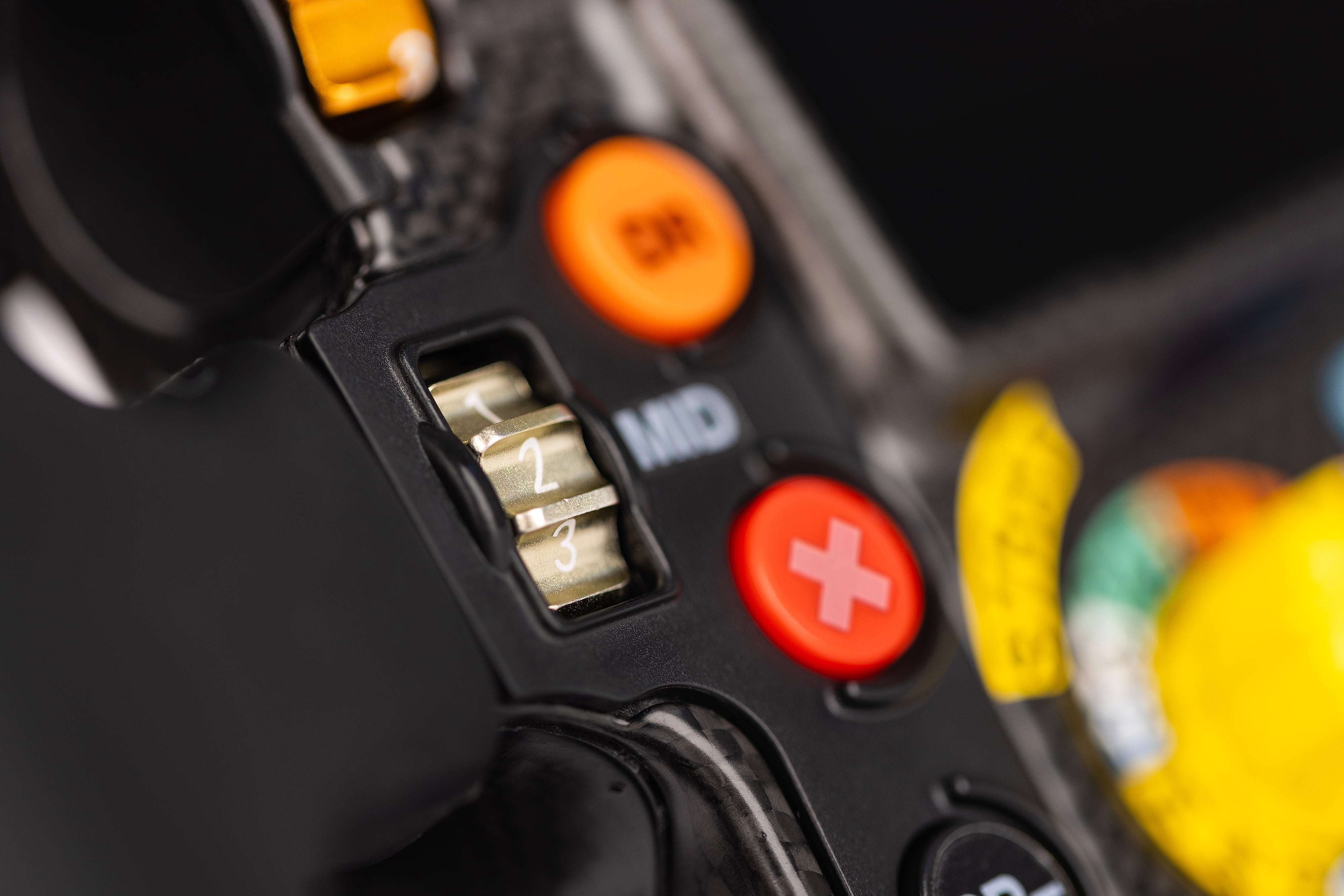 Buttons and rotary switch on the left side of the Mercedes-AMG PETRONAS Formula One Team Sim Racing Steering Wheel (2024).