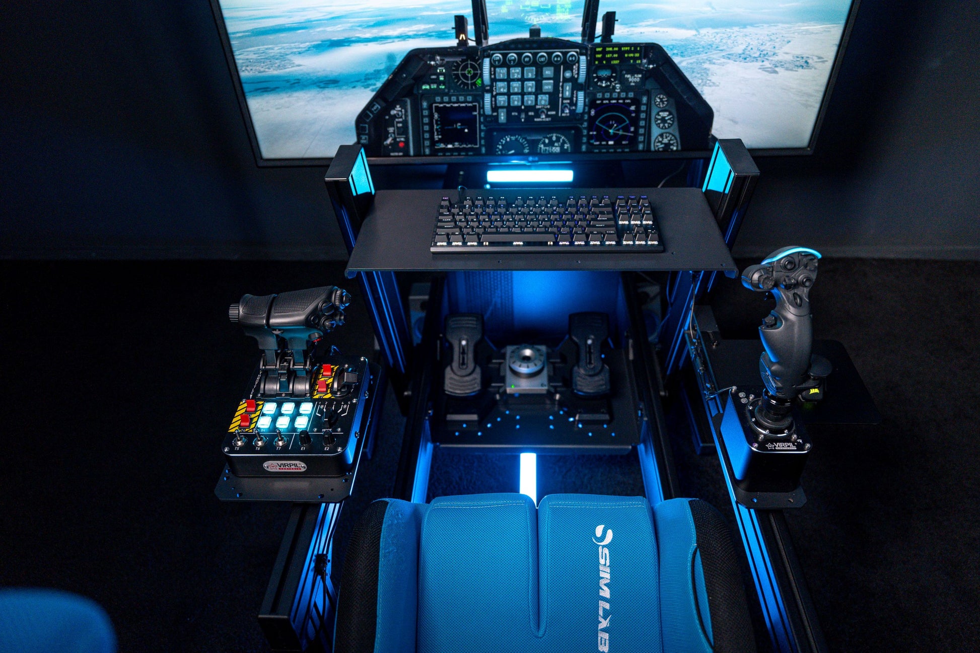 Flight sim cockpit with controls and screens in a dark room