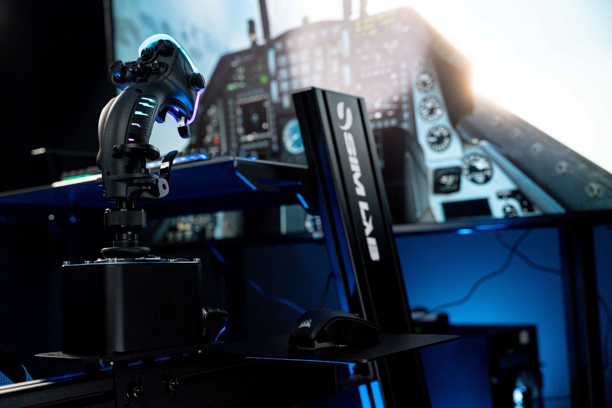 Flight simulator setup with a flight simulator joystick and a monitor displaying a cockpit simulation.