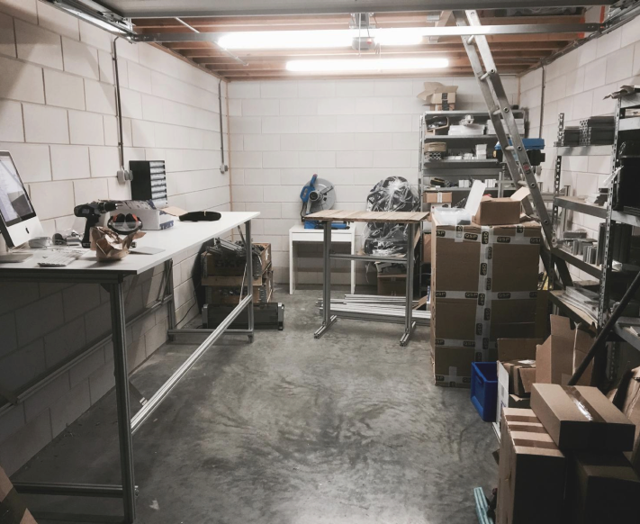 Sim-Lab’s humble beginnings featuring a small warehouse where sim racing parts are being assembled and prepared for shipping.